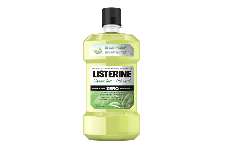 A bottle of LISTERINE® Green Tea Zero Mouthwash, 1 L with a logo of the Canadian Dental Association approval in the background.